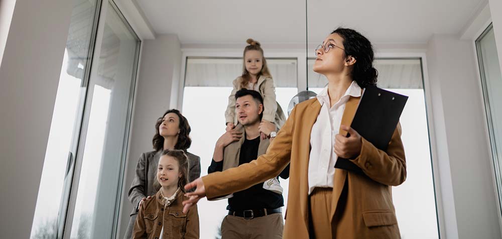 estate agent showing a family around a house